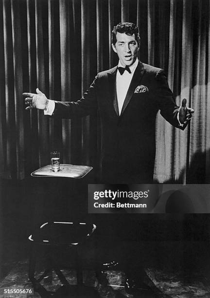 Dean Martin in a tuxedo singing on stage.