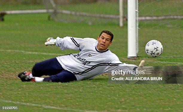 Oscar Cordoba, goalie of the Colombian soccer team, blocks a shot during a training session of the team in Lima, Peru 17 July, 2000. Colombia will...