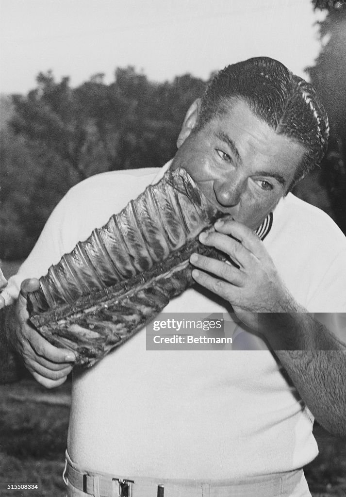 Golfer Ed Oliver Biting into Long Pork Rib Cage