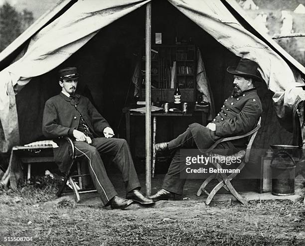 Gettysburg, PA: Dr. C.K. Irwin acting medical director of the Excalibur Brigade seated at the entrance of a tent with another unidentified officer.