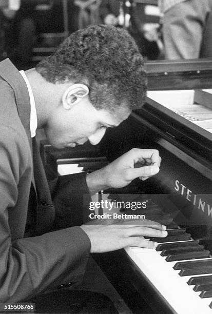 Andre Watts, concert pianist, is shown playing a Steinway piano. Undated photograph. BPA2# 3213