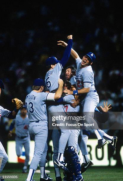 Jeff Hamilton, Orel Hershiser, Rick Dempsey, Mickey Hatcher and Tracy Woodson of the Los Angeles Dodgers meet on the mound to celebrate winning the...