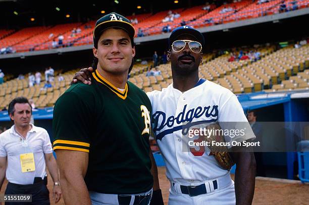 Jose Conseco of the Oakland Athletics and Mike Davis of the Los Angeles Dodgers, former teammates, pose before the competition during the World...