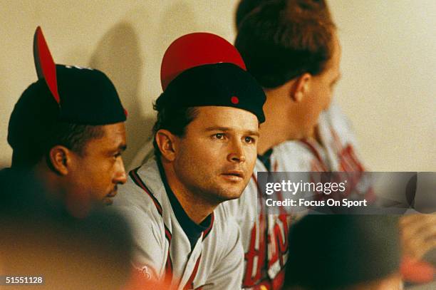 Mark Lemke of the Atlanta Braves joins his teammates as they rally their caps during the World Series against the Minnesota Twins at the Metrodome in...