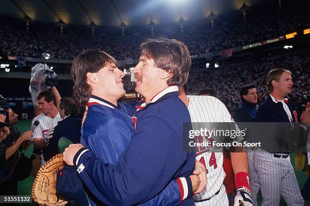 Scott Erickson and Jack Morris of the Minnesota Twins embrace during the Twins' celebration during the World Series against the Atlanta Braves at the...