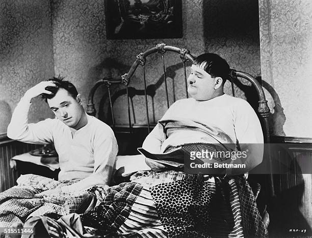 Laurel and Hardy, about to go to sleep. Unidentified movie still.