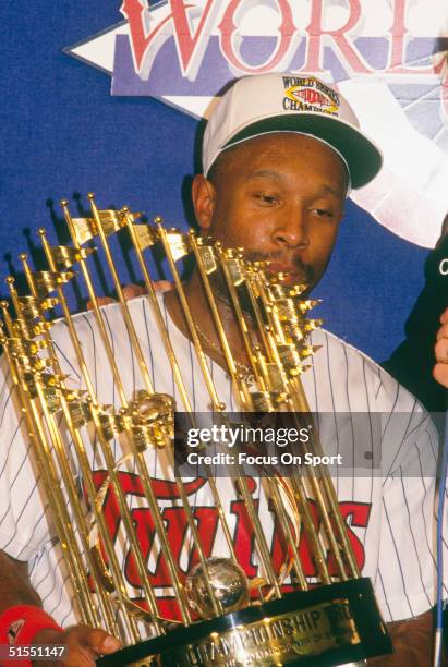 Kirby Puckett of the Minnesota Twins holds the Championship Trophy after defeating the Atlanta Braves in Game 7 of the 1991 World Series on October...