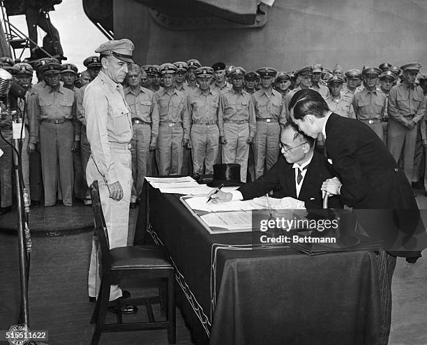 Tokyo Bay: WORLD WAR II: JAPANESE SURRENDER. Namoro Shigomitso signs on behalf Japan and the Japanese government during formal surrender ceremonies...