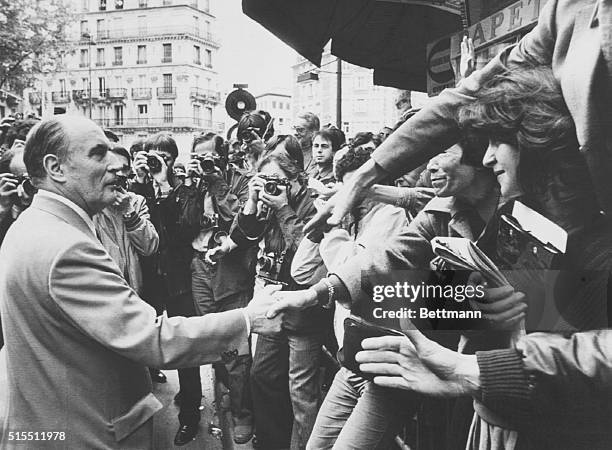 Newly-elected President Francois Mitterand greets supporters near his home.