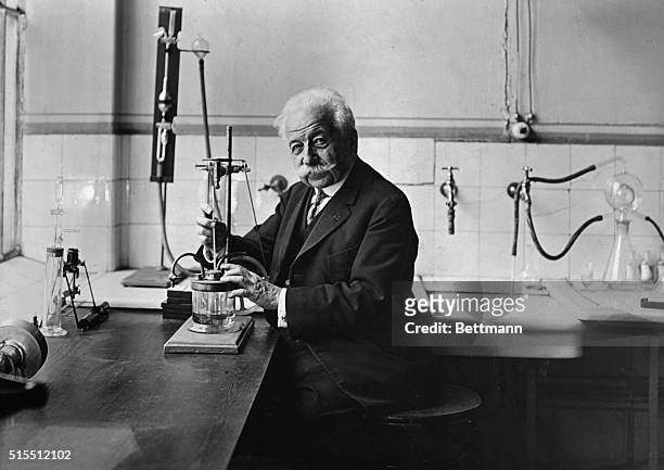 The French chemist and industrialist, August Lumiere , sitting in his laboratory.