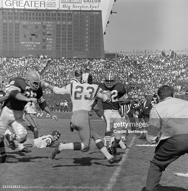 Jim Brown , Cleveland Browns' fullback, picks up enough yardage for a first down in the third quarter. Washington Redskins', Claude Crabb knocks...