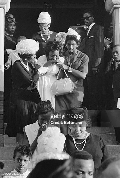 Birmingham, Alabama, 18th September 1963: family members comfort a younger relative as they lead her down the steps following a funeral service for...