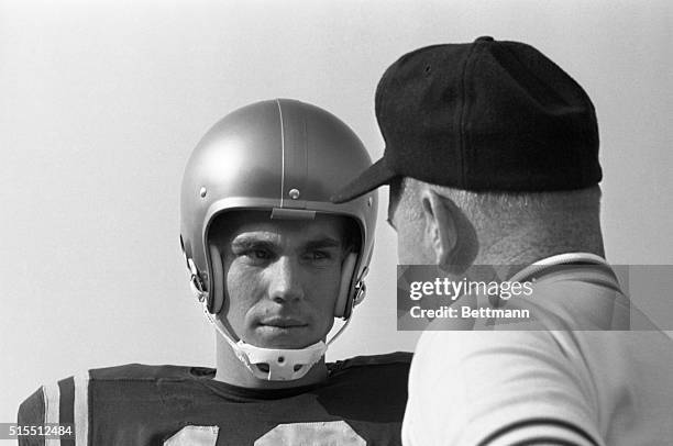 Close-up of Roger Staubach, quarterback, U.S. Naval Academy football team, speaking with coach.