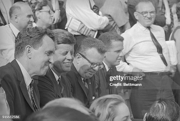 President Kennedy and Senator Edmund Muskie watch a Harvard-Columbia football game at Harvard Stadium. Later the president will attend a Democratic...