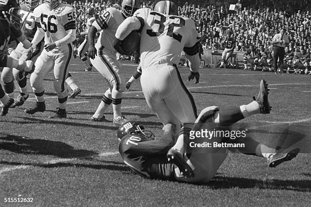 Cleveland Browns steamroller Jim Brown tramples New York Giants Sam Huff as he rumbles for a big gain during the game at Yankee Stadium. Brown...