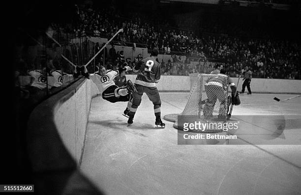 Gordie Howe of the Detroit Red Wings, decks Boston Bruins' Bob Leiter with a body check, during rugged second period action at Boston Garden, 11/3....