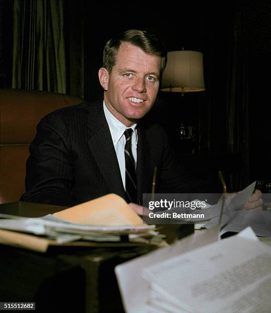 United States Attorney General Robert Kennedy working at his desk.