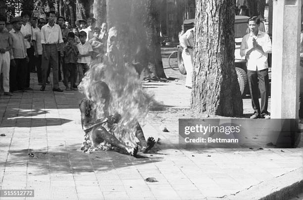 Flames engulf Buddhist Priest Ho Dinh Van in front of the Saigon Roman Catholic Cathedral here on October 27th, as people watch. Hundreds witnessed...