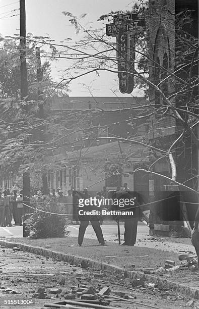 Crowd looks on as FBI bomb experts comb the wreckage in the aftermath of the previous day's bombing of the 16th Street Baptist Church in Birmingham,...