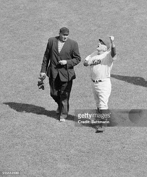 Baseball's grand old man, N. Y. Met's Manager, Casey Stengel waves his arms, , as he argues with plate Umpire Stan Landes over a double down the foul...
