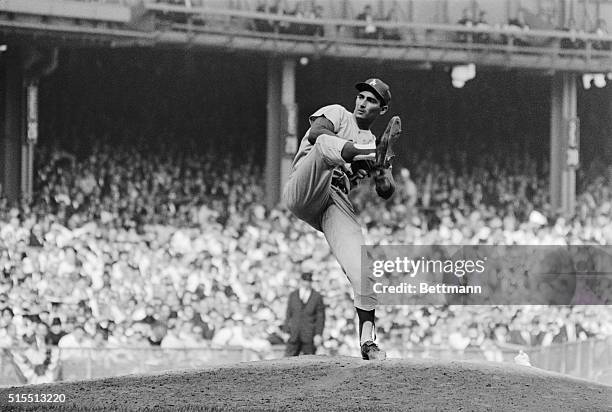 The new World Series strike out king, Los Angeles Dodger Sandy Koufax shows the form that helped him fan 15 Yankee batters in first game here 10/2....