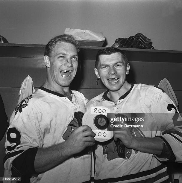 Bobby Hull , of the Chicago Black Hawks, whoops it up with teammate Stan Mikita in the dressing room at Yankee Stadium Dec. 11, following their 6-2...