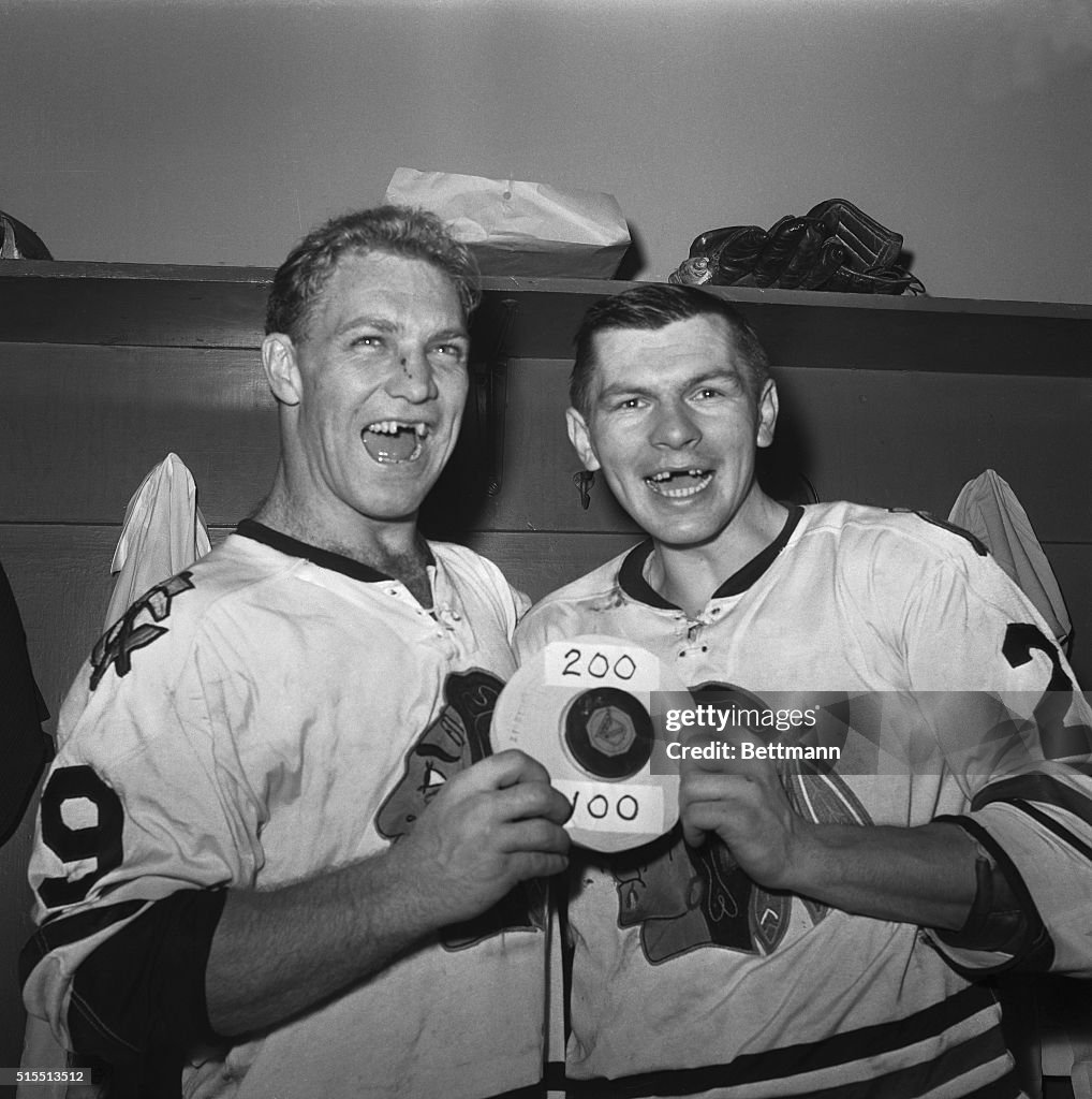 Hockey Players With Puck in Locker Room