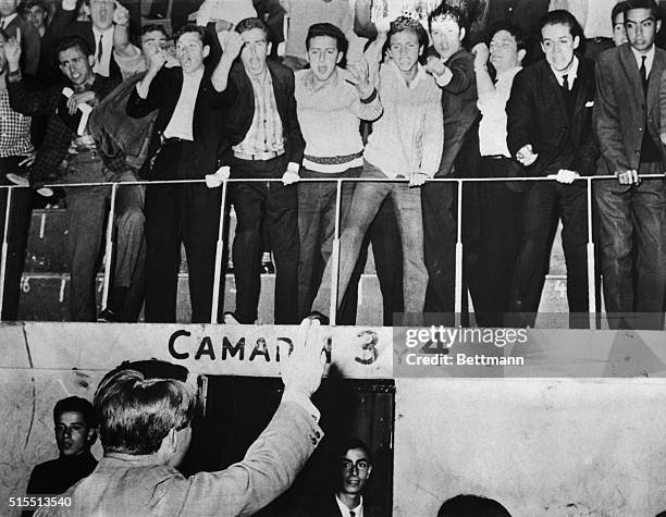 Senator Robert F. Kennedy, , waves to screaming leftist students before attempting to begin a speech at the university here. Angry leftist students...