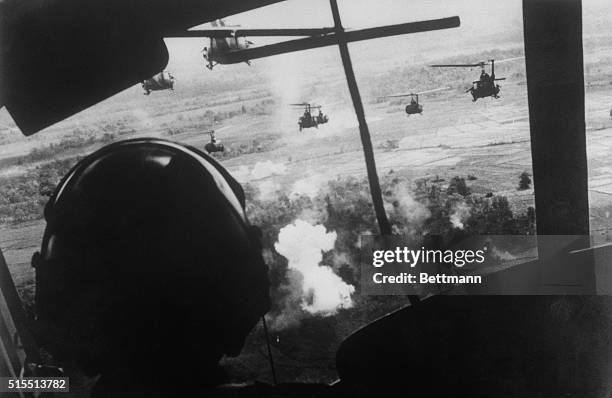 September 18, 1965 - Bien Hoa, South Vietnam: Helicopters, carrying members of the U.S. 173rd Airborne Brigade, fire on a Viet Cong position as they...