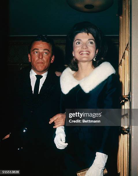 Mrs. Jacqueline Kennedy with her escort, Alan Jay Lerner, arrives at the Mark Hellinger Theater, December 7th, for a performance of On a Clear Day...