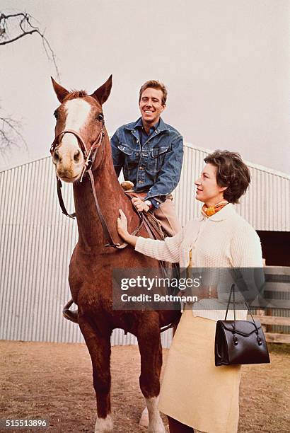 Tucson, Arizona....Princess Margaret appears enthused as Lord Snowdon sits astride a horse at ranch owned by Lewis Douglas, former US ambassador to...