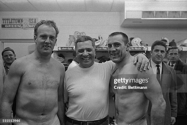 Their faces are marked from the game in mud here January 2nd, against Cleveland Browns, but half back Paul Hornung and Jim Taylor have no problem...