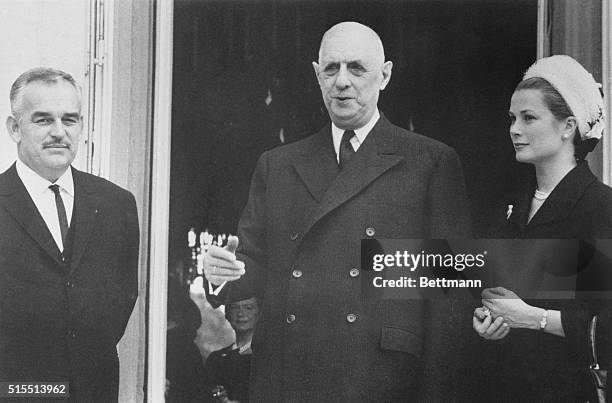 De Gaulle and Monaco's Royal Couple. Paris: French President Charles de Gaulle stands with Prince Rainier of Monaco and Princess Grace on the steps...