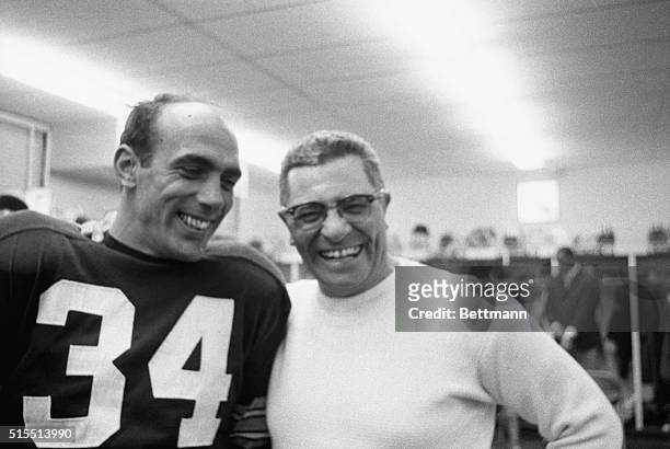 Packer coach Vince Lombardi and star kicker Don Chandler find it easy to turn on wide smiles in dressing room here December 26th. Packers had just...