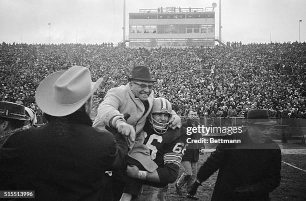 Happy coach is Packerson Vince Lombardi as he is carried off field by Ray Nitschke after team beat Baltimore Colts 13-10 in sudden death period of...