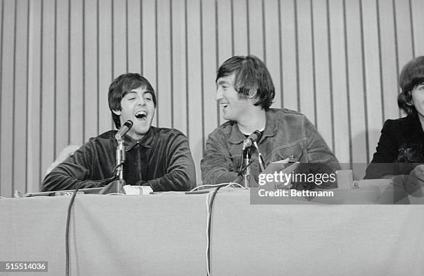 Portland, Ore.: John Lennon smiles as Paul McCartney speaks at press conference held after Beatles performance in Portland.