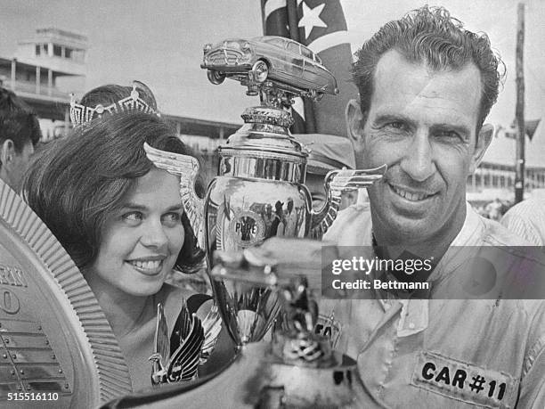 Ned Jarrett of Camden, S.C., won the 16th annual Southern 500 here 9/6 and carried away $22, 100 in prize money. A proud winner, Jarrett holds his...