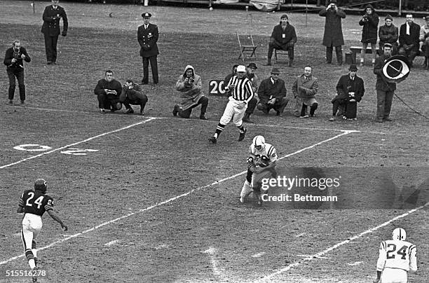 Baltimore Colts' quarterback Johnny Unitas struggles to hold the ball as a host of Detroit Lions tacklers threw him for an 8-yard loss during the 3rd...