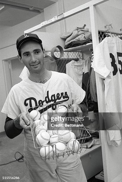Twenty wins is a basketfull in anybody's league, and Dodger pitcher Sandy Koufax holds up 20 baseballs in the dressing room after he became the first...