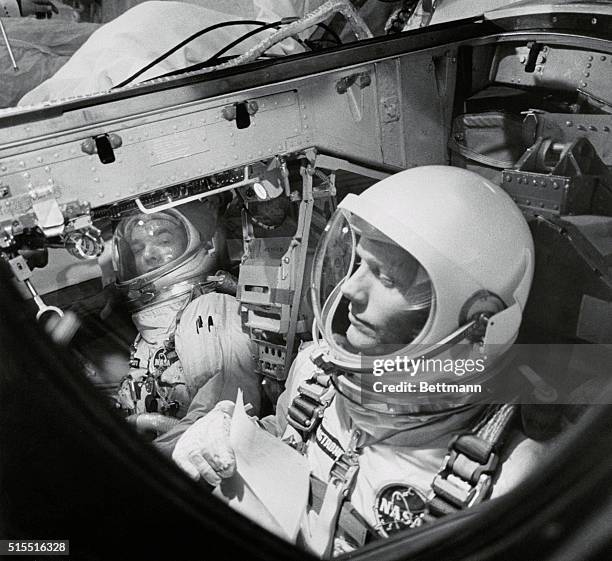 Cape Kennedy: Gemini 8 crew, Neil Armstrong and David Scott shown in the spacecraft as they ran through a flight simulation test atop the Titan 11...