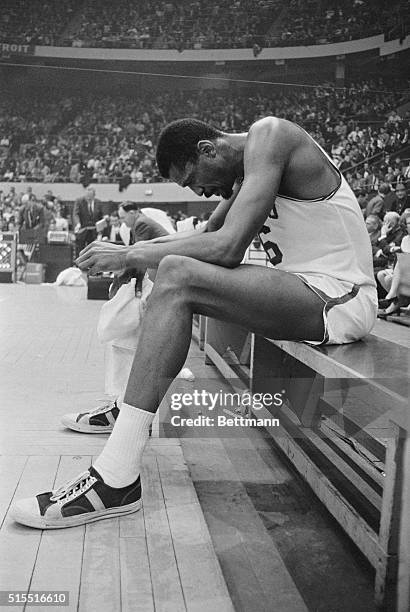 Boston, Massachusetts: Bill Russell of the Boston Celtics appears dejected while sitting alone on bench as the Cincinnati Royals regained their one...