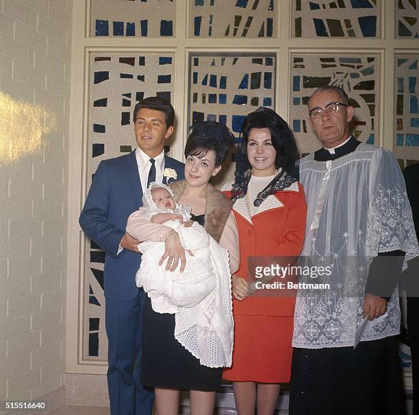 Encino, California: Actress Annette Funicello poses with the godparents of her child, baptized Gina Luree. At left is singer Frankie Avalon who is...