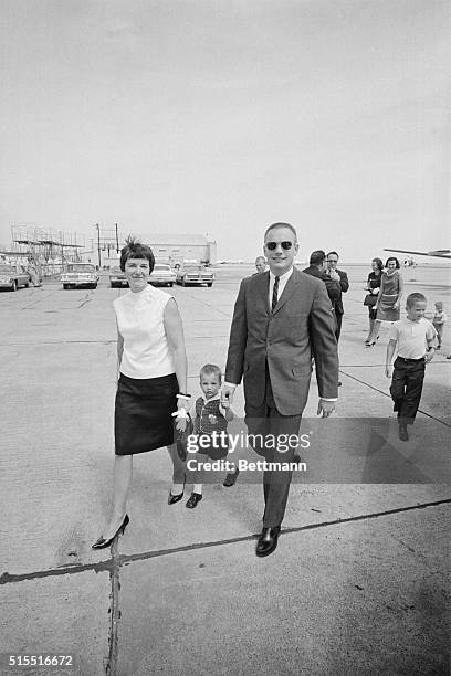 Gemini 8 Command Pilot Neil A. Armstrong leaves Ellington Air Force Base with his wife Janet, and their two-year-old son Mark in this photo, as he...