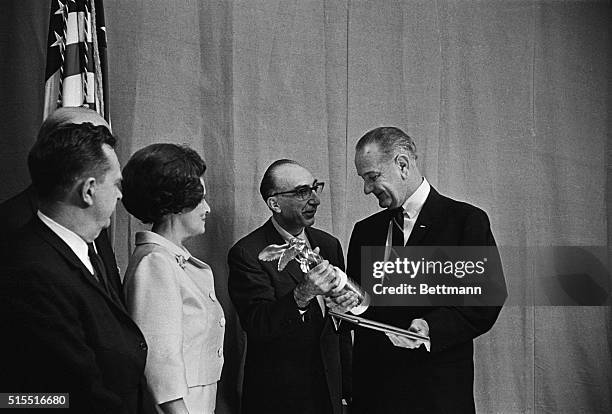 In a ceremony at the White House, President Johnson receives the Albert Lasker special award for this--- "outstanding contribution to the health of...