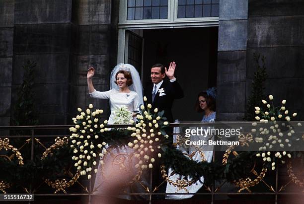 Crown Princess Beatrix and her husband, Claus von Amsberg, wave from a balcony of the royal palace here, March 10, following their wedding. The...