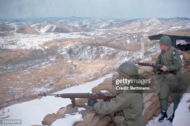 Korea: American troops in the demilitarized zone of Korea keep watch over the area from behind sandbag barricades.