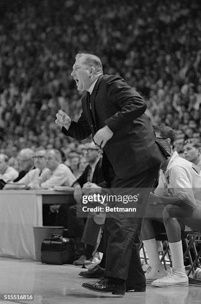 Texas Western's coach Don Haskins comes off the bench to cheer his team during the second game of the NCAA championship play offs at the University...