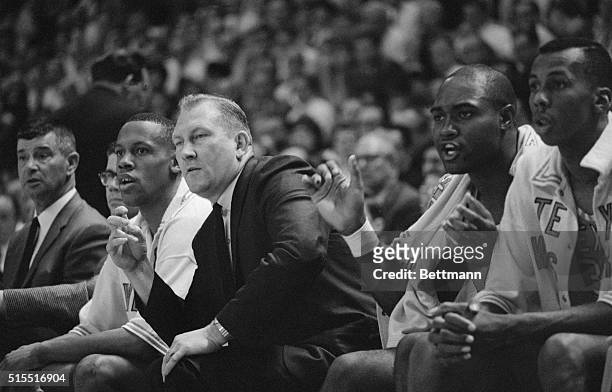 Texas Western coach Don Haskins, , and one of his players, Willie Cager, cheer on the Miners during the second game of the NCAA championship play...