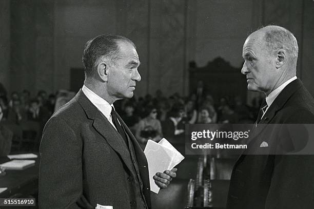 Senator J. William Fulbright , chairman of the Senate Foreign Relations Committee, speaking to George Kennan in room of hearing.