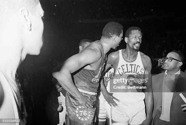 Bill Russell of the Celtics turns a deaf ear on Wilt Chamberlain of the 76ers.